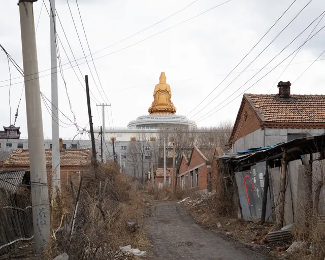 An alley and a Buddha statue.